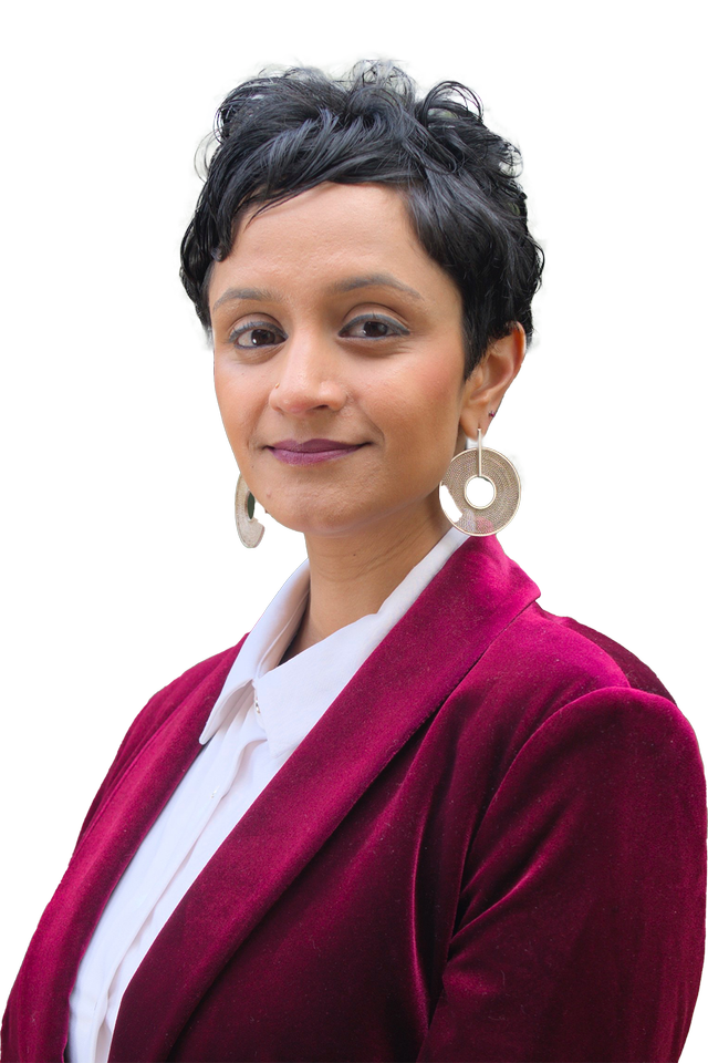 Janani Ramachandran in red velvet suit.